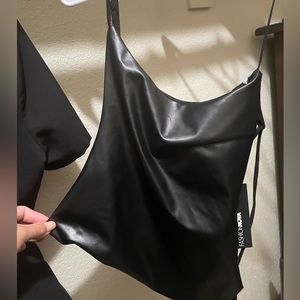 X-large leather top with strings on the back . Brand new tags still on